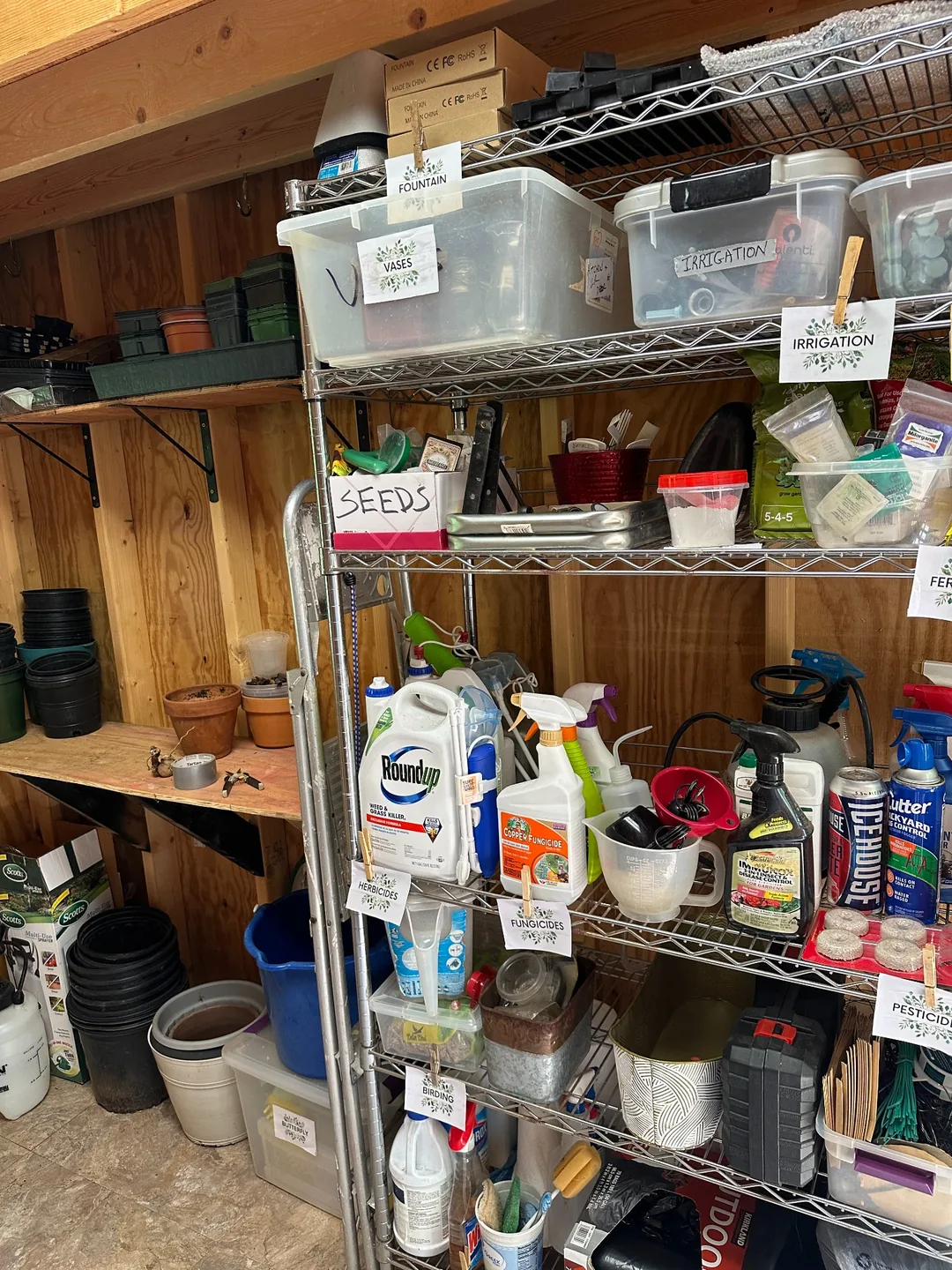 Garden supplies grouped on labeled shelving.
